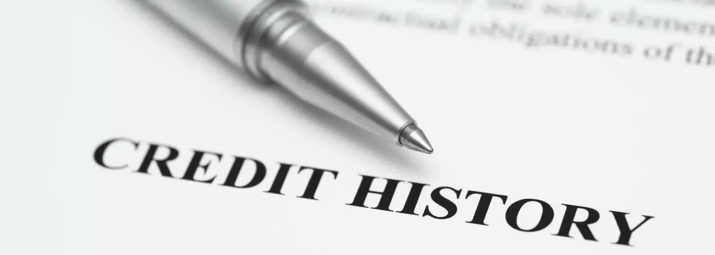 Pen resting on a document titled "Credit History," emphasizing financial records.