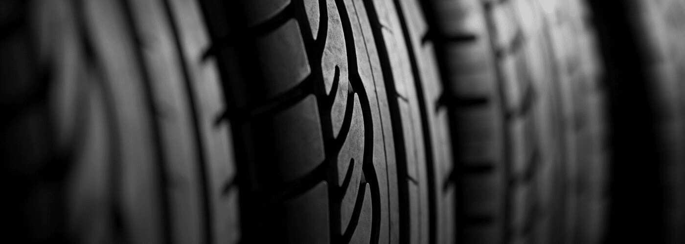 Close-up of tire treads, showcasing detailed patterns and texture, emphasizing automotive quality.