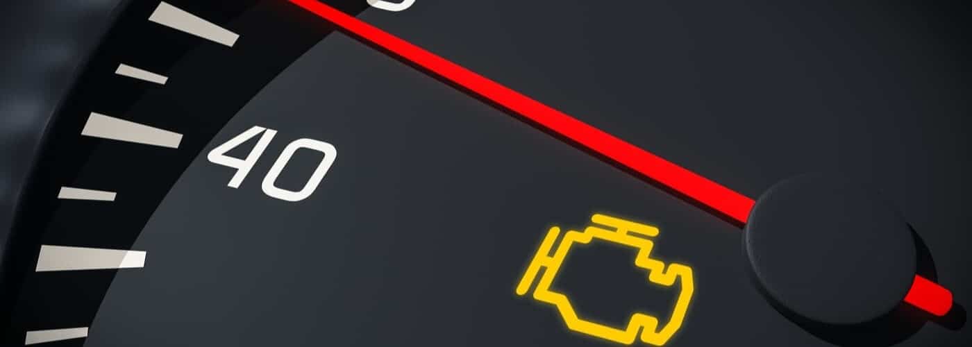 Close-up of a car speedometer showing 40 with a yellow check engine light illuminated.